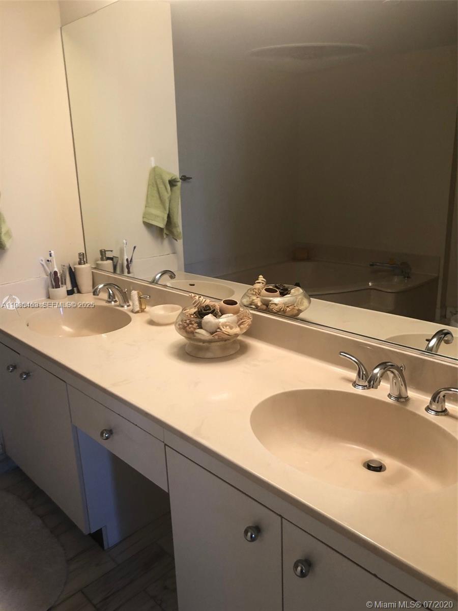 2000 Towerside Terrace, Unit 905 Miami, FL 33138 - Photo 15 of 24 a bathroom with a sink and a mirror