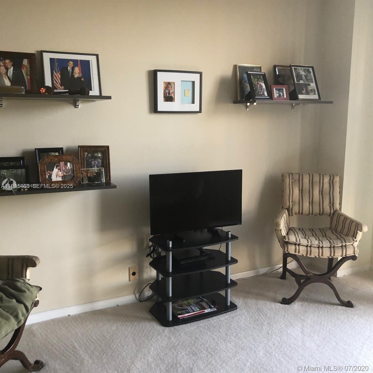 2000 Towerside Terrace, Unit 905 Miami, FL 33138 - Photo 16 of 24 a view of a livingroom with furniture and a flat screen tv