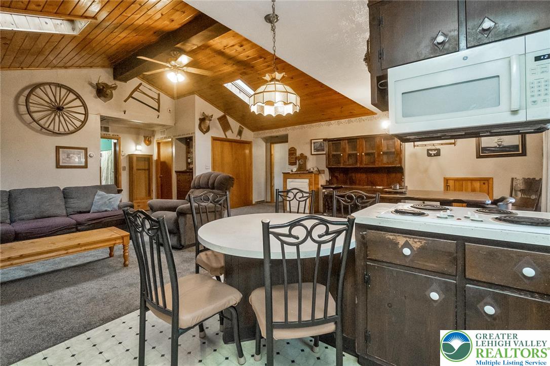 9223 North Loop Road Slatington, PA 18080 - Photo 32 of 60 a kitchen with a stove a table and chairs in it