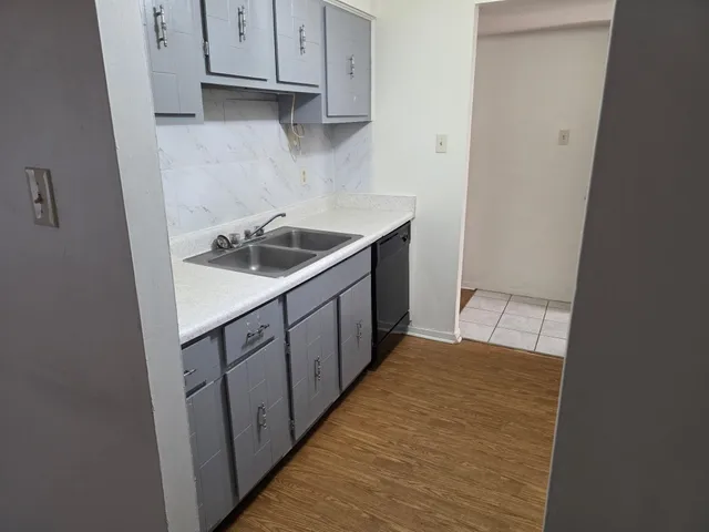 a kitchen with a sink and a stove