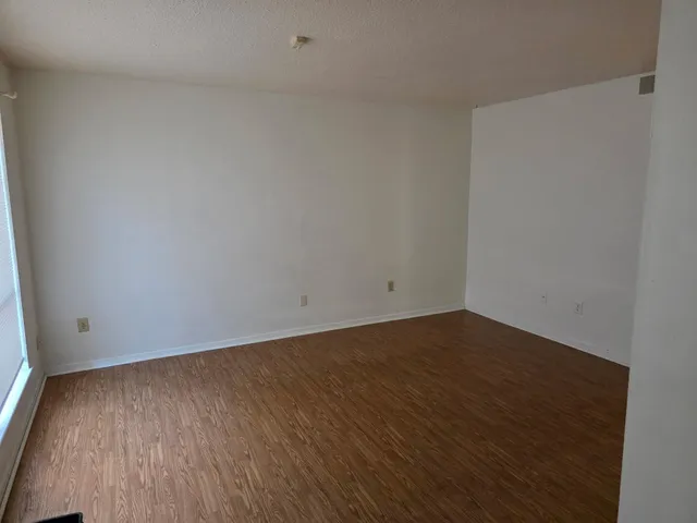 a view of a room with wooden floor