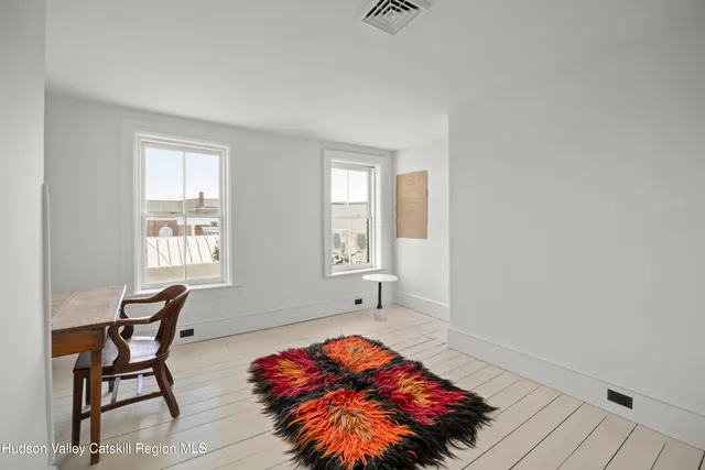 a bedroom with a bed and chair