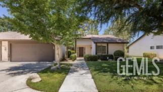 Undisclosed Address Bakersfield, CA 93309 - Photo 3 of 3 a front view of a house with garden