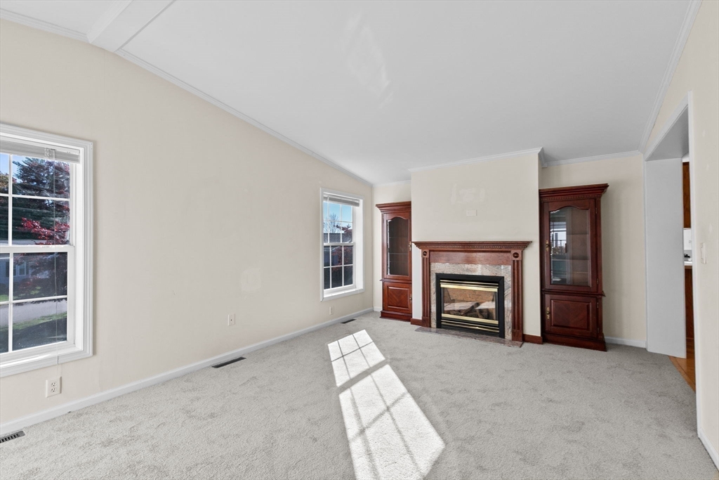 2602 Pheasant Lane Middleboro, MA 02346 - Photo 15 of 40 an empty room with furniture and a fireplace