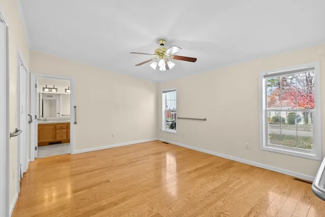 a view of a room with window and a ceiling fan
