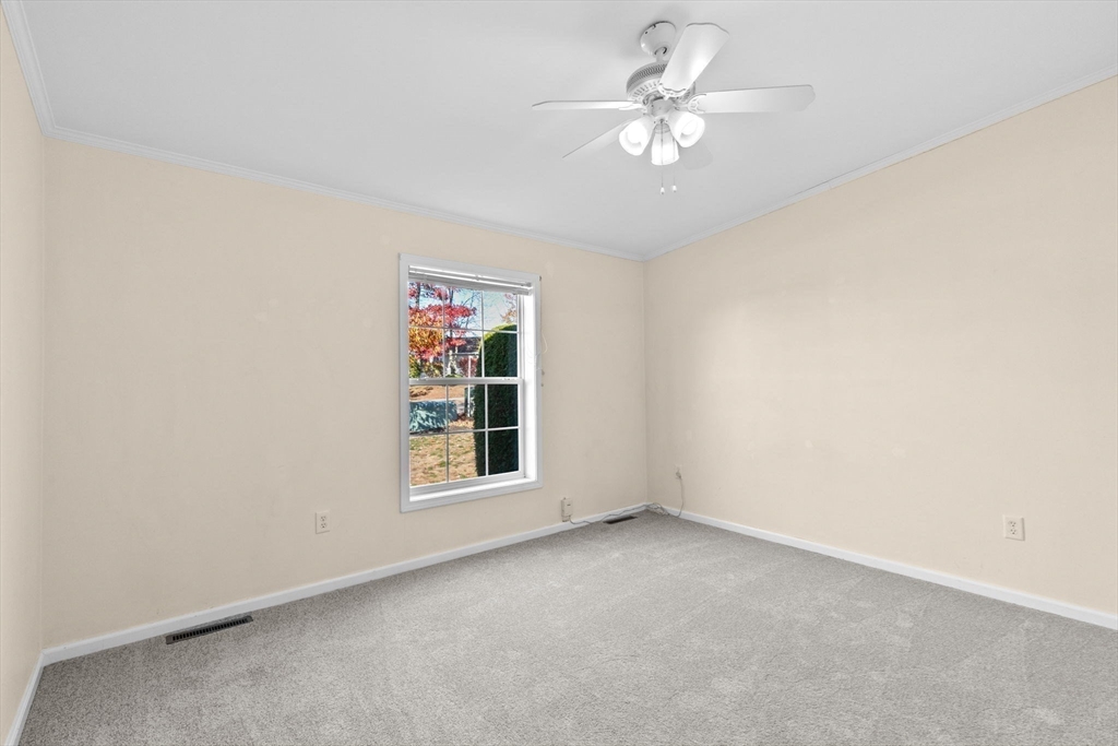 2602 Pheasant Lane Middleboro, MA 02346 - Photo 24 of 40 an empty room with windows and ceiling fan
