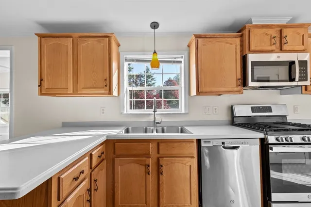 a kitchen with stainless steel appliances a sink stove and a window