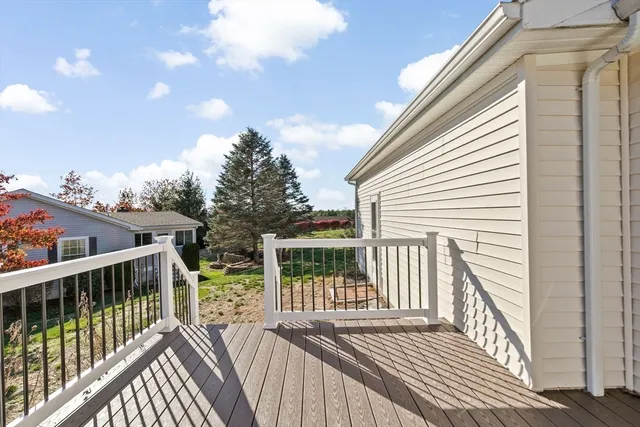 a view of balcony with wooden floor and fence
