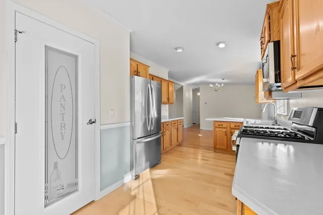 a kitchen with stainless steel appliances granite countertop a refrigerator and a stove