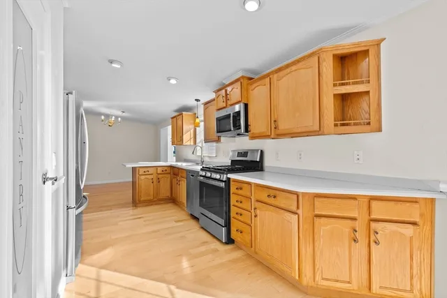 a kitchen with stainless steel appliances granite countertop a stove and a refrigerator