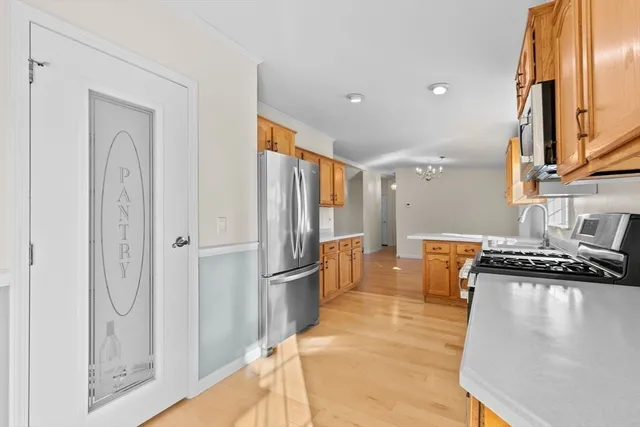 a kitchen with stainless steel appliances granite countertop a refrigerator and a stove