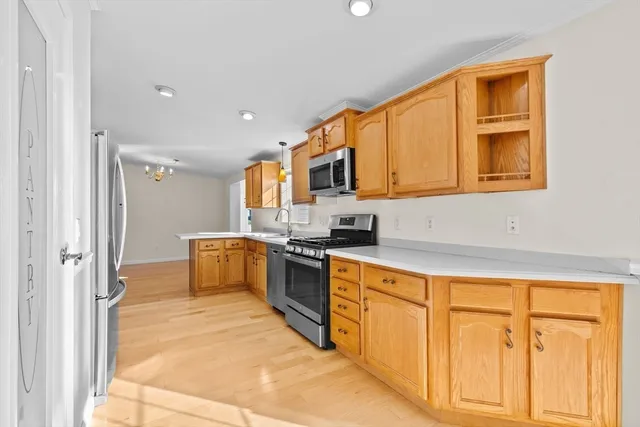 a kitchen with stainless steel appliances granite countertop a stove and a refrigerator