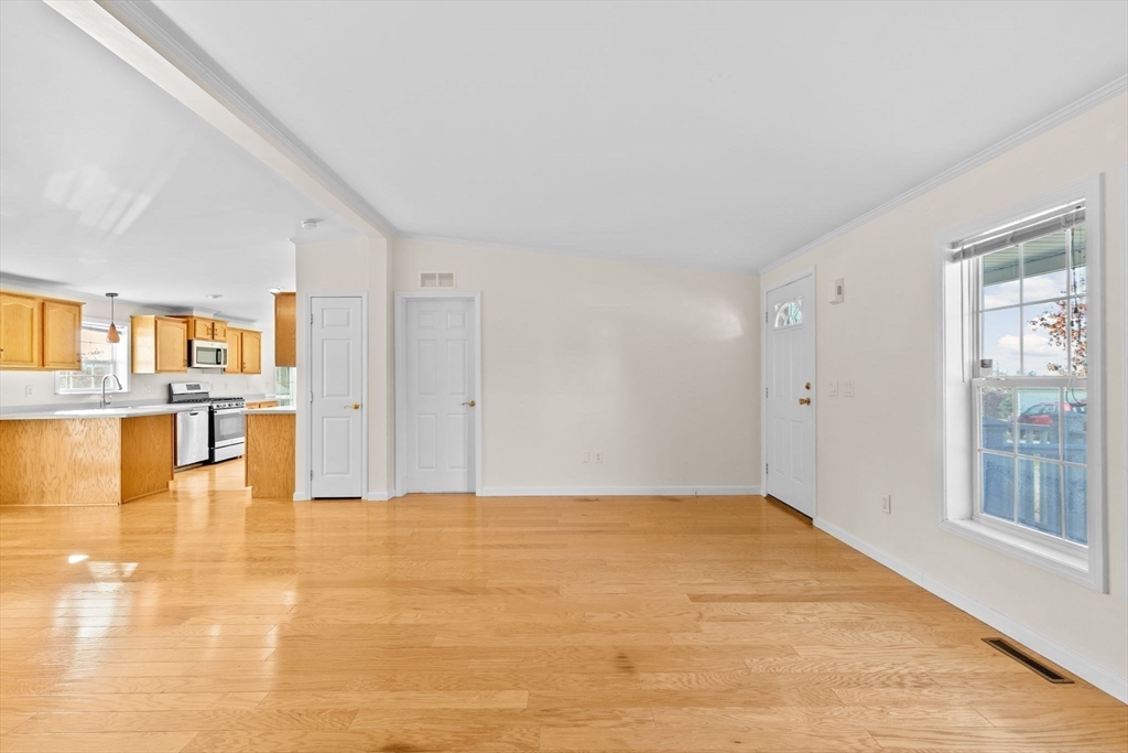 2602 Pheasant Lane Middleboro, MA 02346 - Photo 10 of 40 a view of empty room with kitchen view and glass door