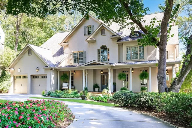a living room with furniture a large window and a fireplace