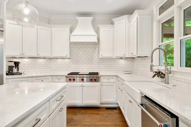 a bathroom with a sink a light fixture a mirror and a shower