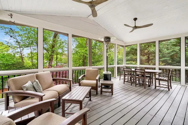a utility room with stainless steel appliances granite countertop a sink and a window
