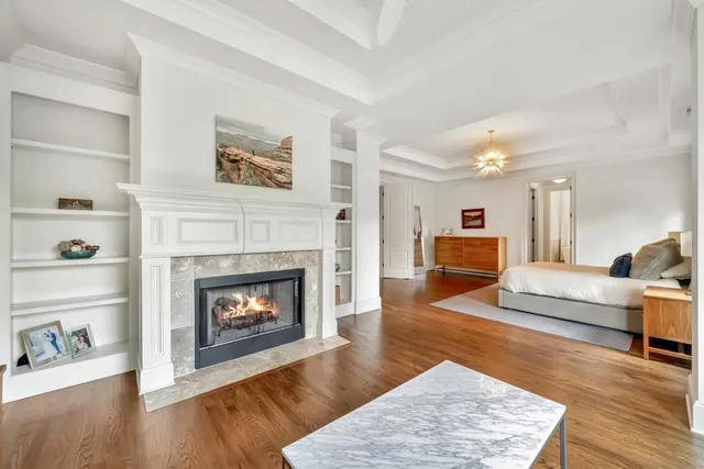 a living room with furniture and a baby crib