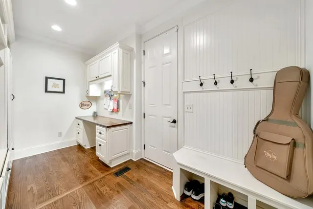a view of backyard with a table and chairs and potted plants