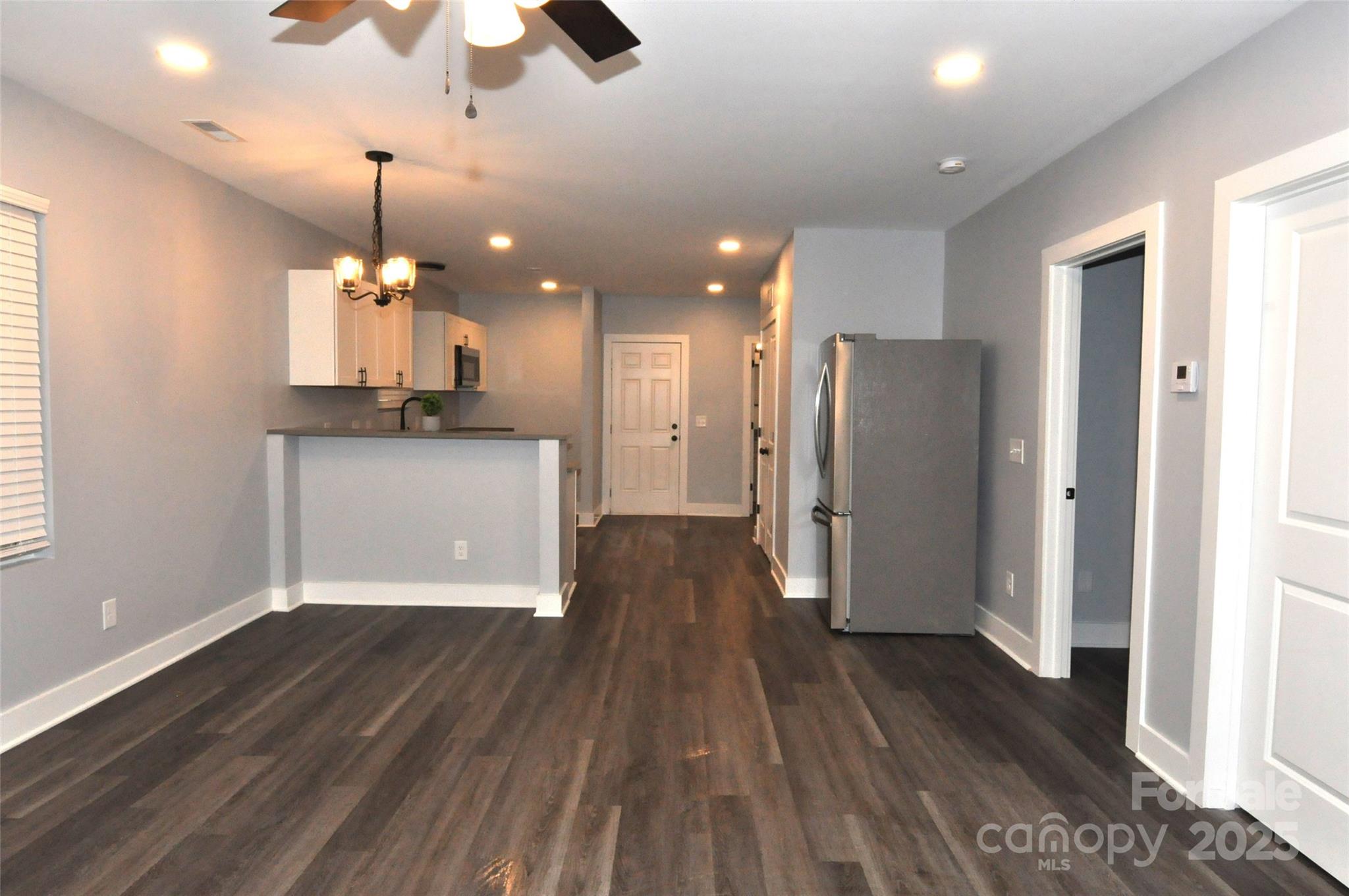 560 2nd Street, Unit 16 Chester, SC 29706 - Photo 13 of 25 a view of a kitchen with a refrigerator wooden floor and a window