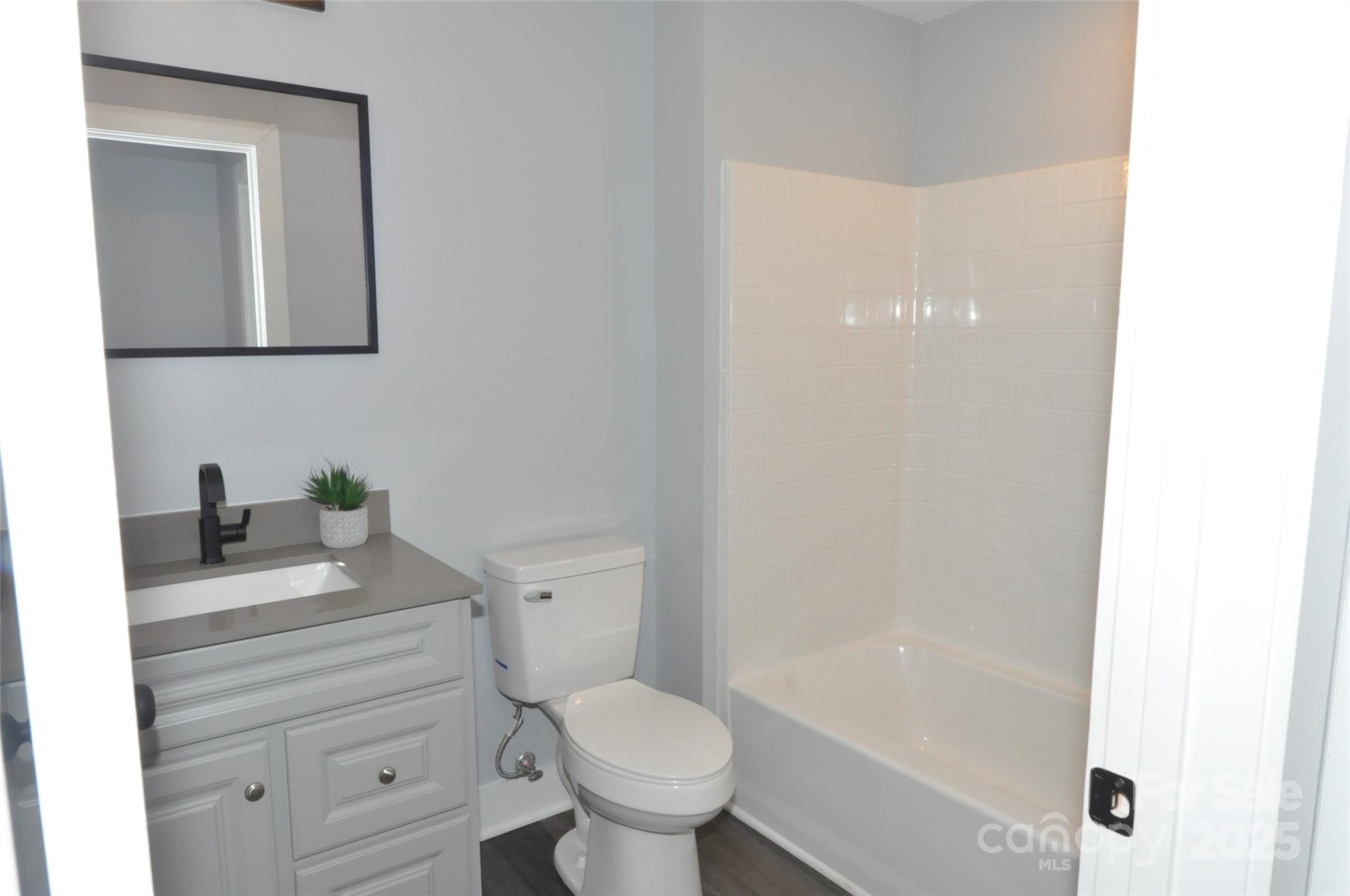 560 2nd Street, Unit 16 Chester, SC 29706 - Photo 17 of 25 a bathroom with a granite countertop toilet a sink and a bathtub