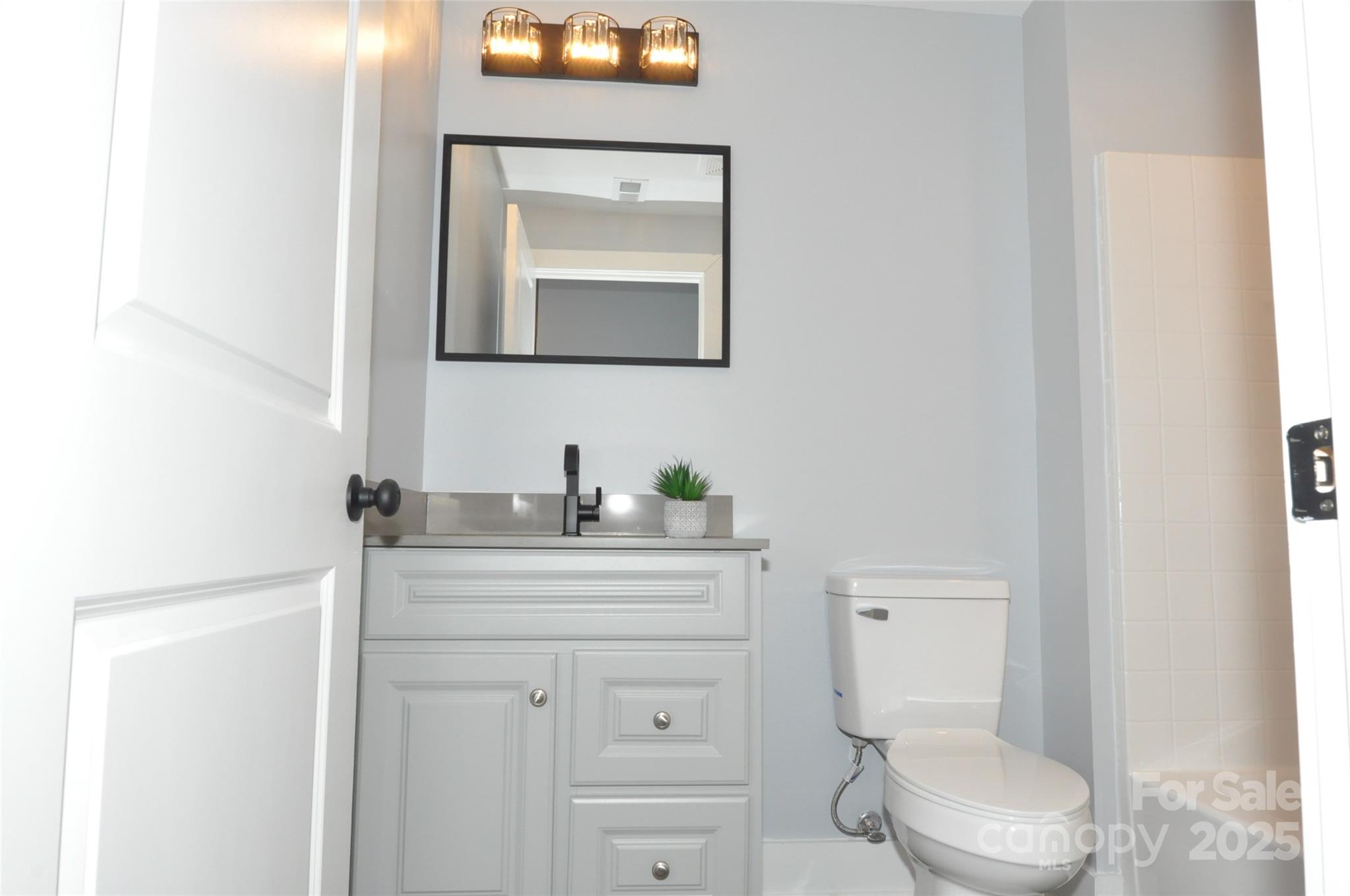 560 2nd Street, Unit 16 Chester, SC 29706 - Photo 18 of 25 a bathroom with a toilet a sink a vanity and mirror