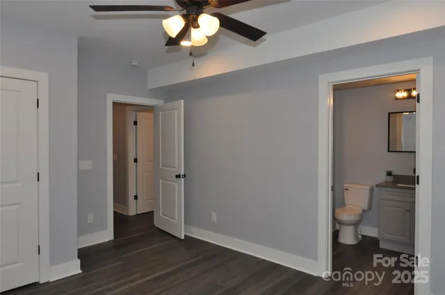 a bathroom with a toilet and a light fixture