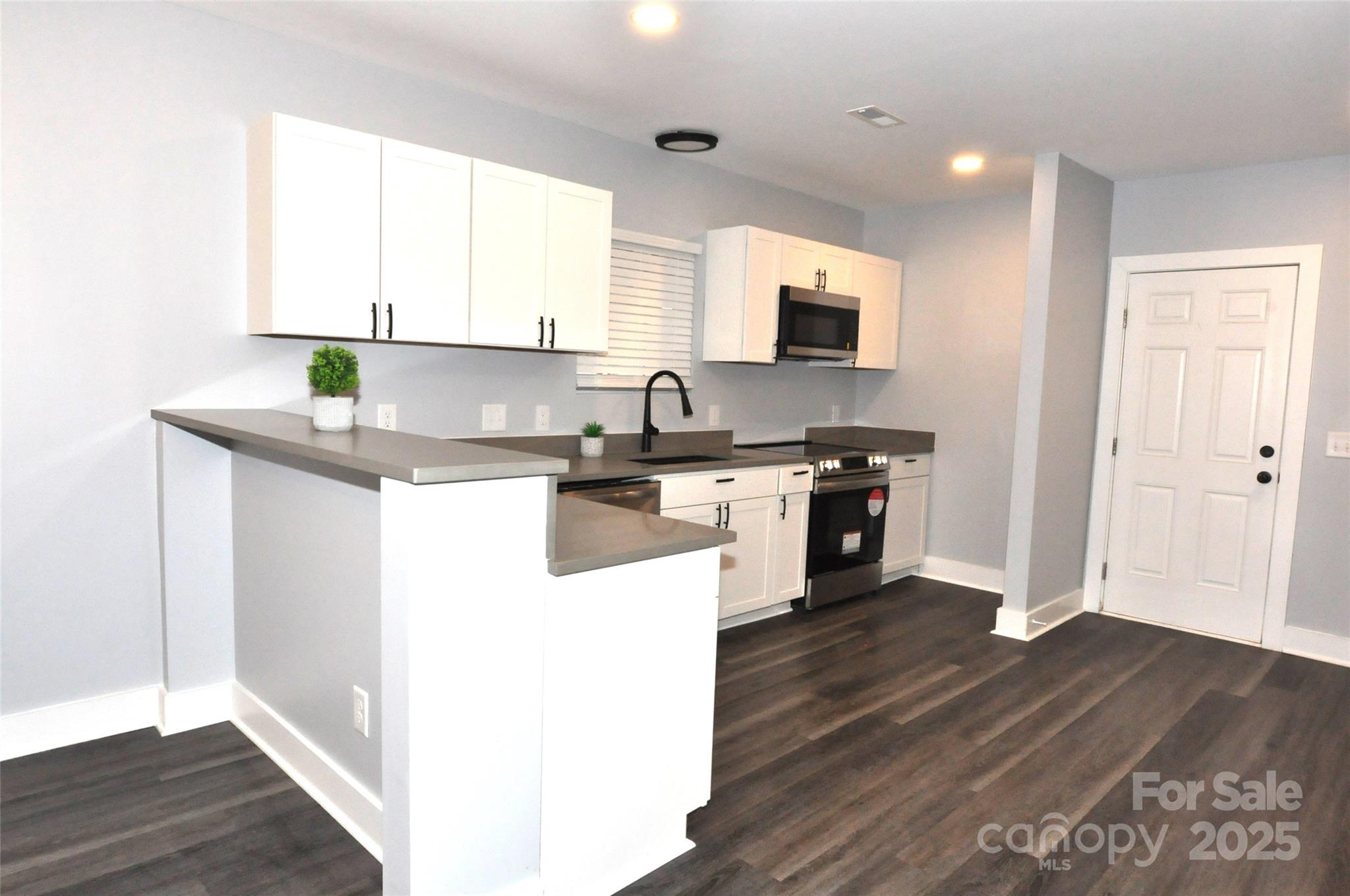 560 2nd Street, Unit 16 Chester, SC 29706 - Photo 8 of 25 a kitchen with stainless steel appliances granite countertop a sink a stove and cabinets