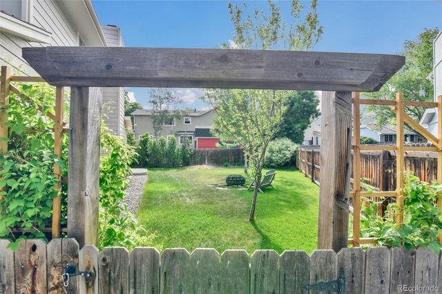 a view of a backyard with plants and a backyard