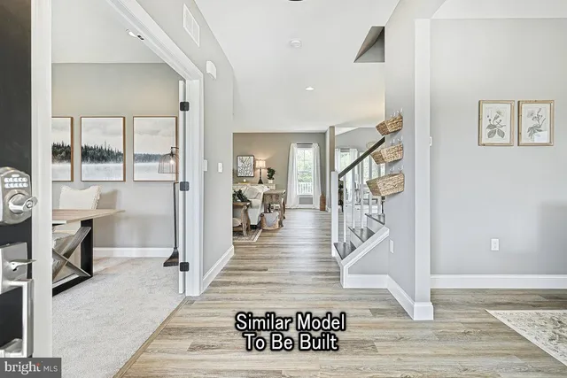 a view of entryway and hall with wooden floor