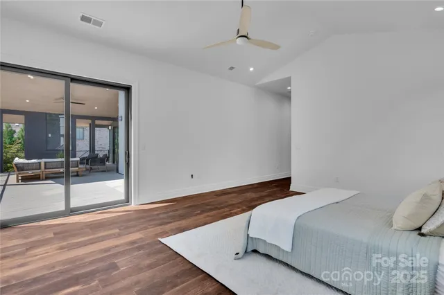 a bedroom with a bed and glass door