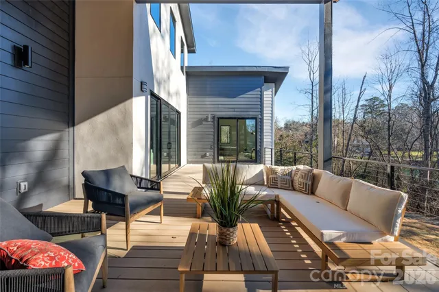 a view of balcony with couches and potted plants