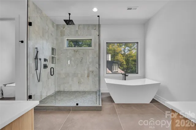 a bathroom with a bathtub and a shower