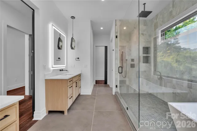 a bathroom with a granite countertop sink mirror and shower