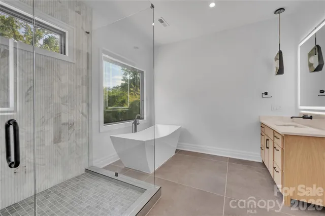 a bathroom with a sink a mirror and a bathtub