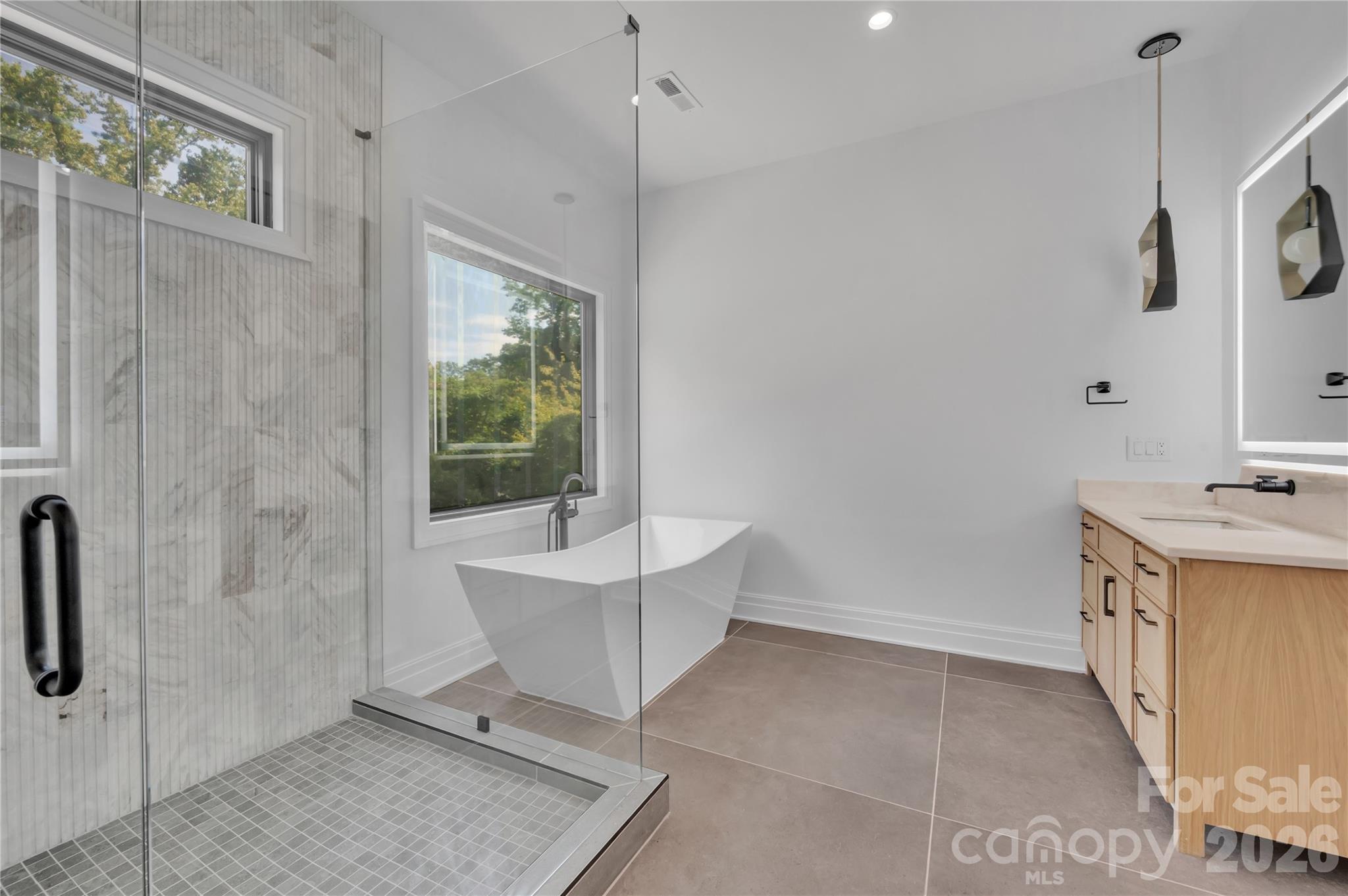 1423 South Wendover Road Charlotte, NC 28211 - Photo 19 of 31 a bathroom with a sink a mirror and a bathtub