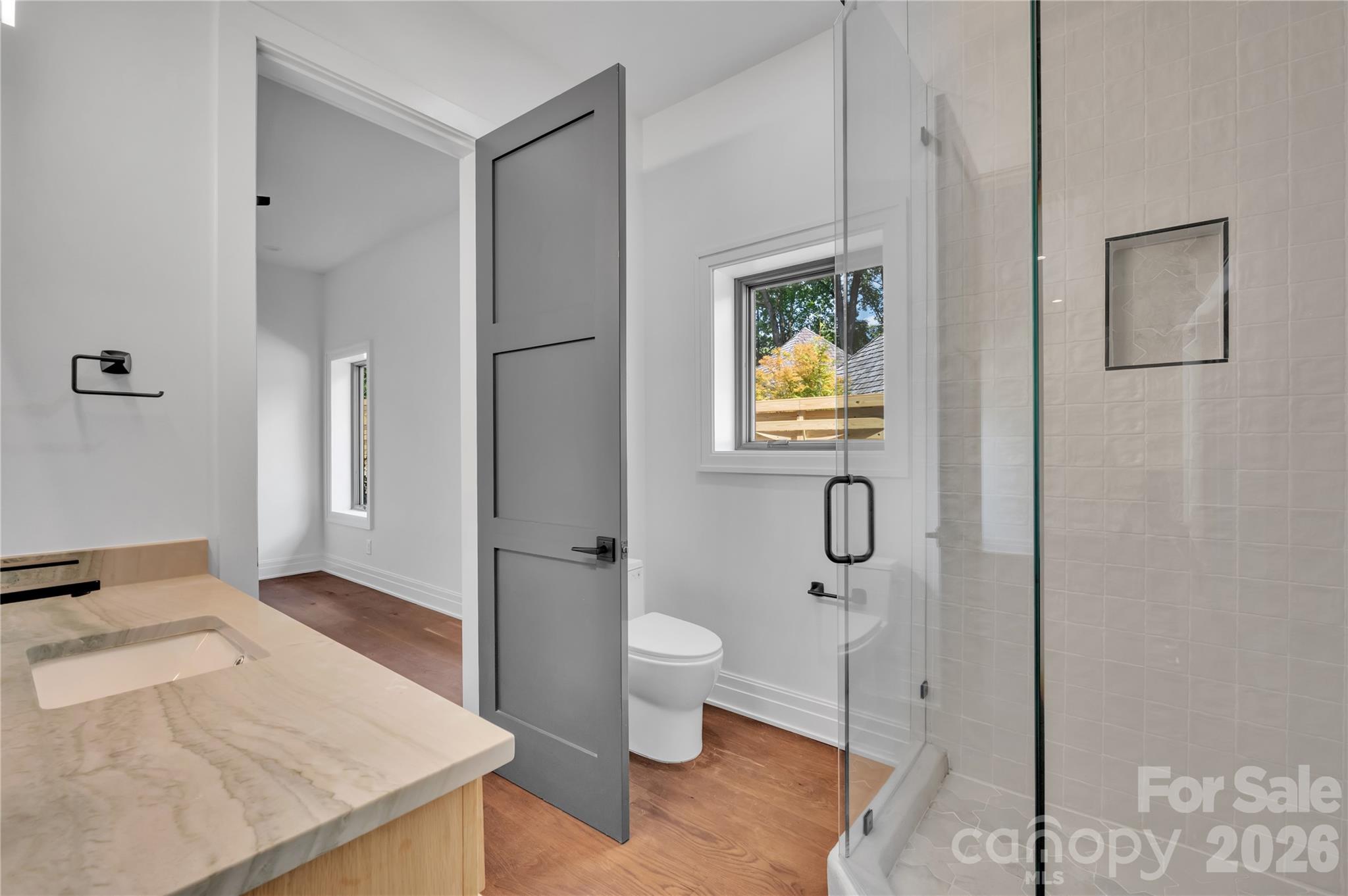 1423 South Wendover Road Charlotte, NC 28211 - Photo 25 of 31 a bathroom with a granite countertop sink a toilet and shower