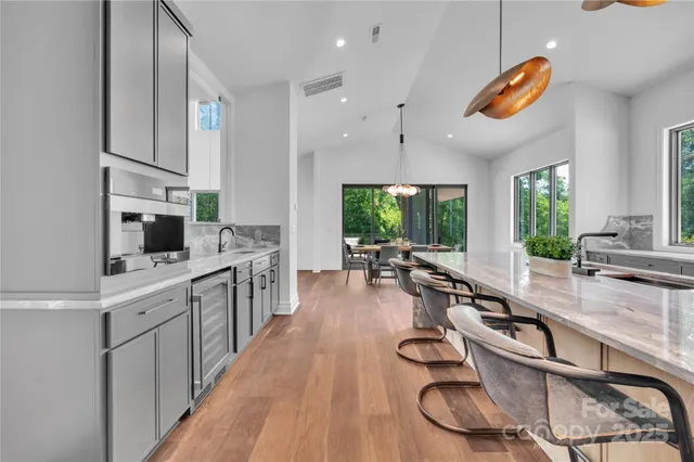 a kitchen with kitchen island granite countertop lots of counter top space and a sink