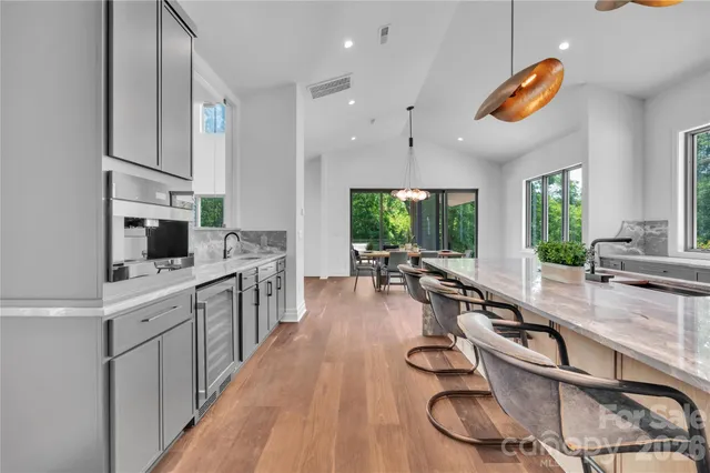 a kitchen with kitchen island granite countertop lots of counter top space and stainless steel appliances