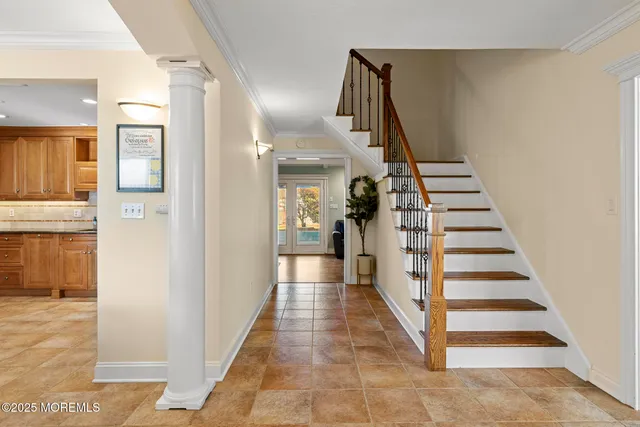 a view of a hallway with a white walls and stairs