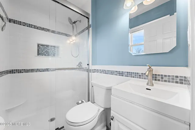 a bathroom with a sink a mirror and a toilet