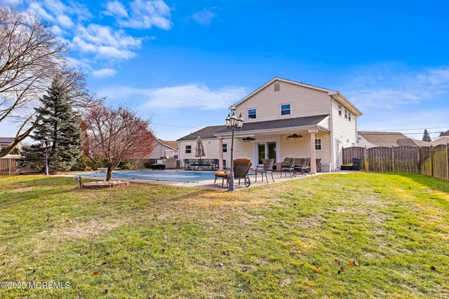 a view of a house with swimming pool and sitting area