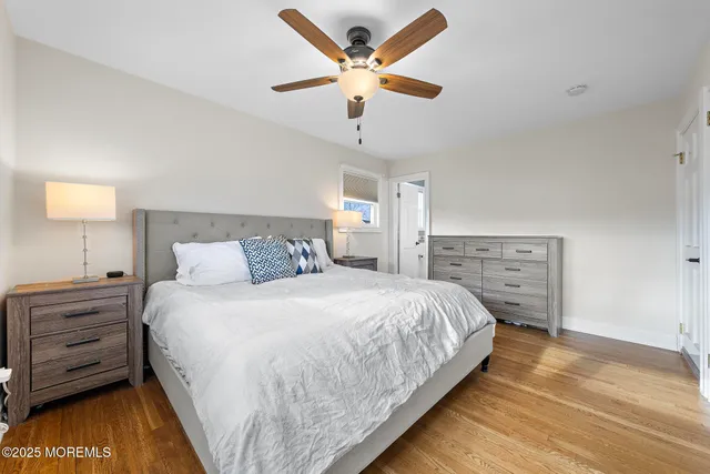 a bedroom with a bed and a ceiling fan