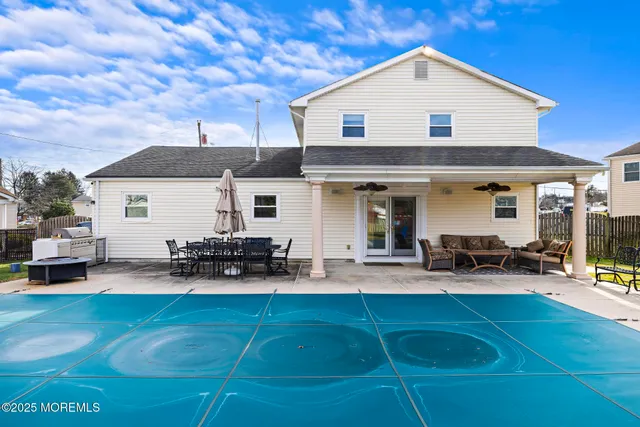 a front view of a house with patio and a yard