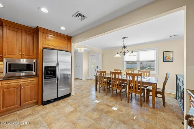 a large kitchen with lots of furniture and stainless steel appliances