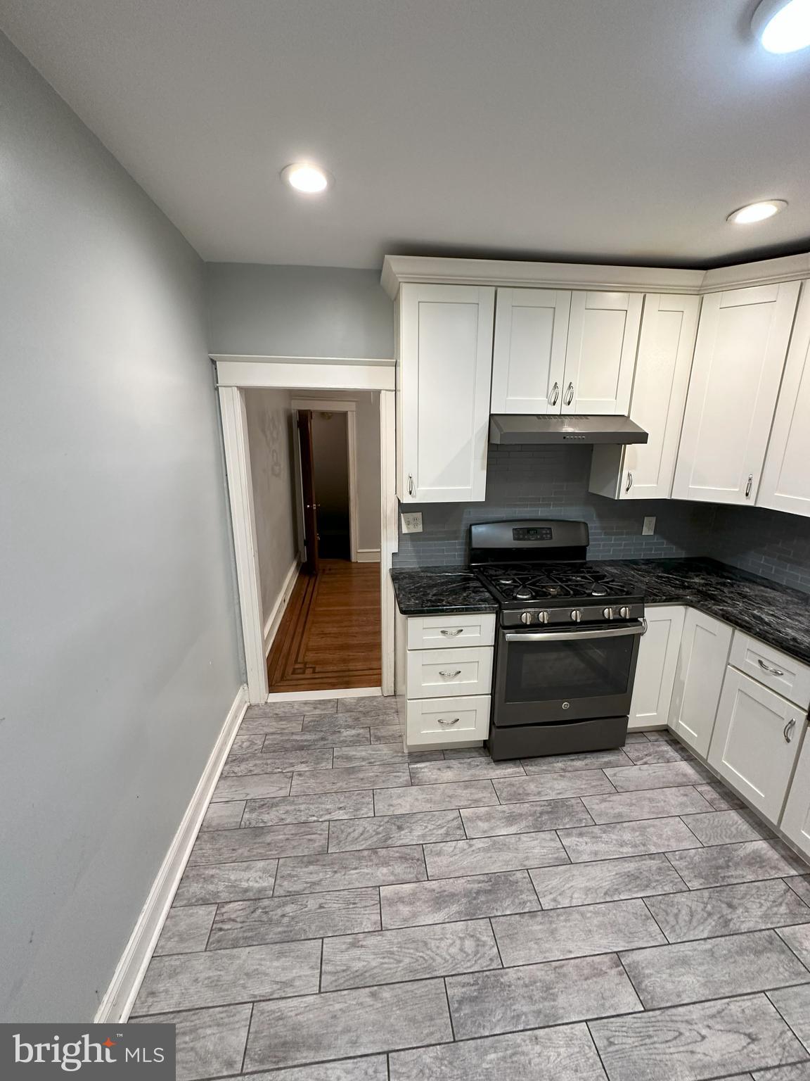 1126 Sanger Street Philadelphia, PA 19124 - Photo 4 of 21 a kitchen with a stove a sink and a microwave