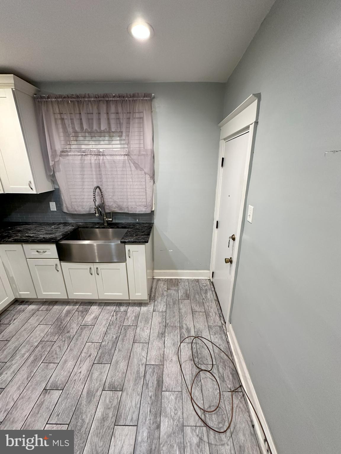1126 Sanger Street Philadelphia, PA 19124 - Photo 6 of 21 a view of a room with wooden floor and cabinets