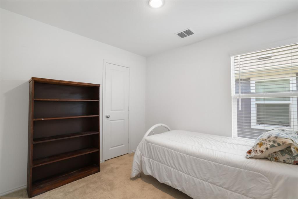 1445 Sterling Way Ferris, TX 75125 - Photo 7 of 17 Bedroom featuring light carpet