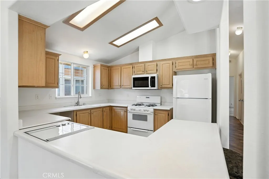 27250 Murrieta Road, Unit 216 Menifee, CA 92586 - Photo 11 of 58 a kitchen with stainless steel appliances granite countertop a sink stove and refrigerator