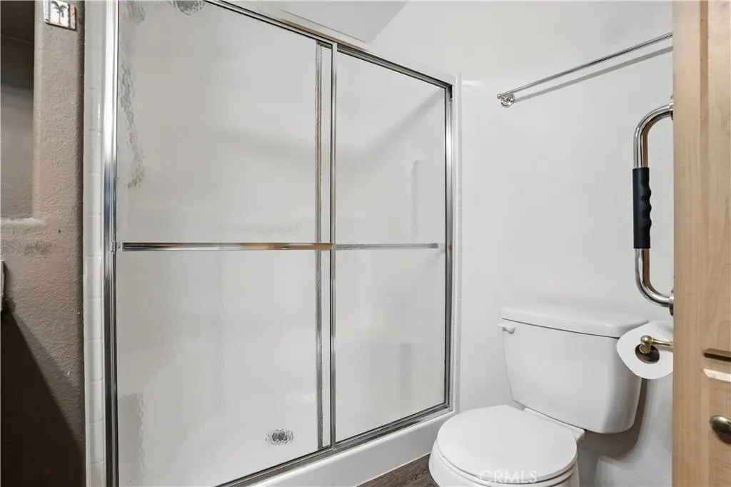 27250 Murrieta Road, Unit 216 Menifee, CA 92586 - Photo 21 of 58 a white toilet sitting next to a bathroom sink