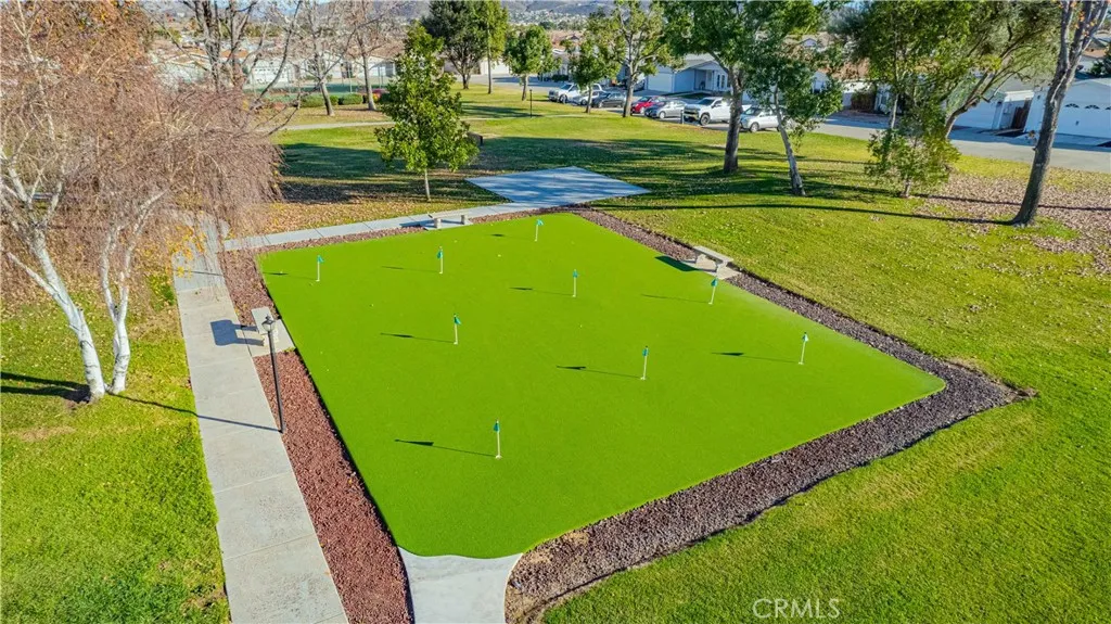 27250 Murrieta Road, Unit 216 Menifee, CA 92586 - Photo 47 of 58 a view of a pool with a garden and trees